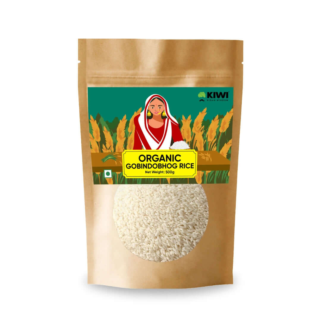 A pile of Natural Gobindobhog Rice grains, small and pearly white, on a plain background.