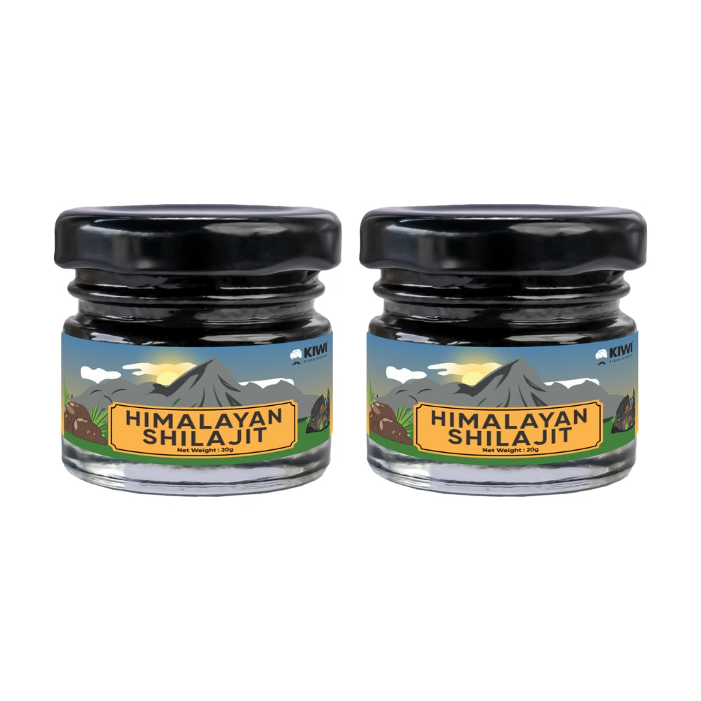 Himalayan Shilajit resin in a small glass jar with a wooden applicator.