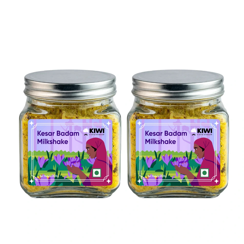 A glass of Kesar Badam Milk Shake, creamy and golden, garnished with saffron threads and almond slivers.